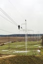 A team of workers inspects high-voltage electrical line